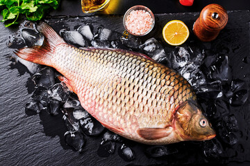 Beautiful, fresh, raw fish (carp) lies on the ice.