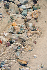 Various colored stones in water stream