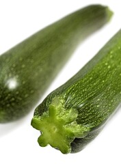 LONG COURGETTE OR ZUCCHINI AGAINST WHITE BACKGROUND