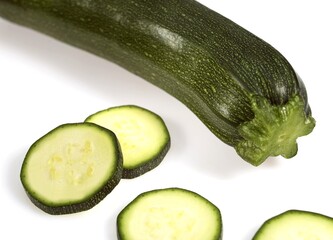 LONG COURGETTE OR ZUCCHINI AGAINST WHITE BACKGROUND