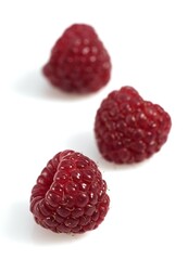 RASPBERRIES AGAINST WHITE BACKGROUND