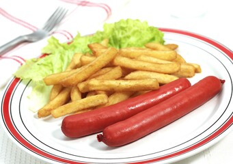 PLATE WITH SAUSAGES, FRENCH FRIES AND SALAD