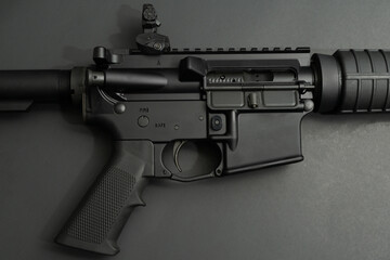 Close up view of black AR-15 on black background. 