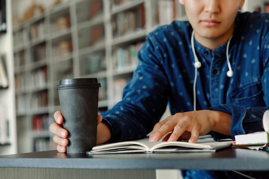 Crop guy reading in library