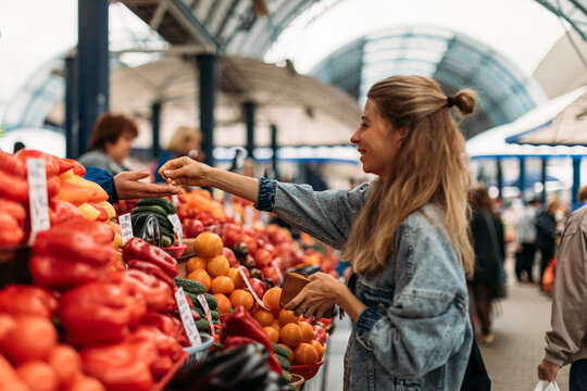 Woman buying fruits and vegetables on the market.