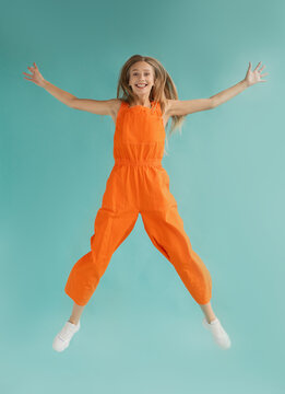 Colorful female jumping up with excitement