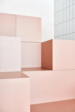 Peach-colored cubes in room near white wall