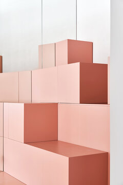 Peach-colored cubes in room near white wall