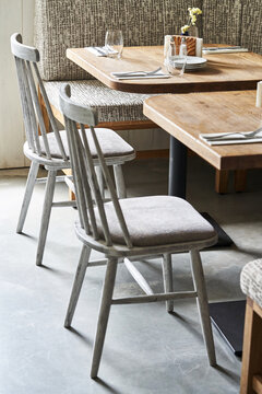 Gray chairs with padded seat at tables
