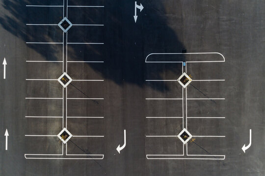 Aerial view of freshly marked road way asphalt carpark
