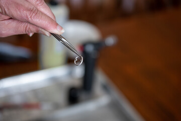 Woman making jewelry pendent