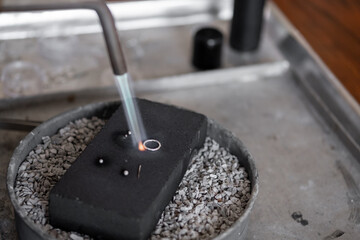 Woman making jewelry pendent