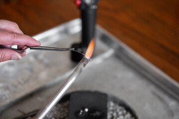 Woman making jewelry pendent