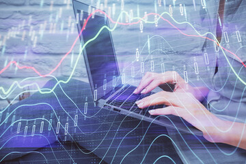 Multi exposure of woman hands typing on computer and forex chart hologram drawing. Stock market analysis concept.