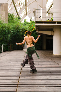 Hula hoop dancer walking in pavilion