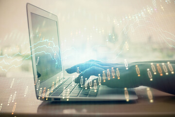 Double exposure of woman hands typing on computer and forex chart hologram drawing. Stock market invest concept.