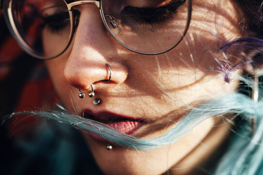 Alternative blue haired lady with glasses and piercing