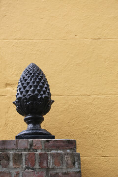 Pineapple Sculpture On A Brick Ledge