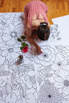 Female Artist Drawing Flower Patterns At The Studio