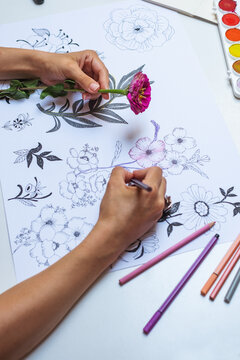 Anonymous artist drawing flowers on paper