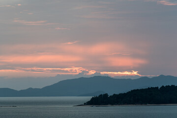 Beautiful first light from sunrise on island mountain with color sky 
