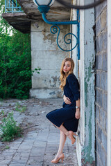 Young woman standing next to an old building