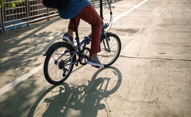 Man riding folding bicycle to work