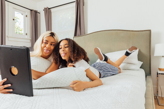 Two Sisters Play on Tablet