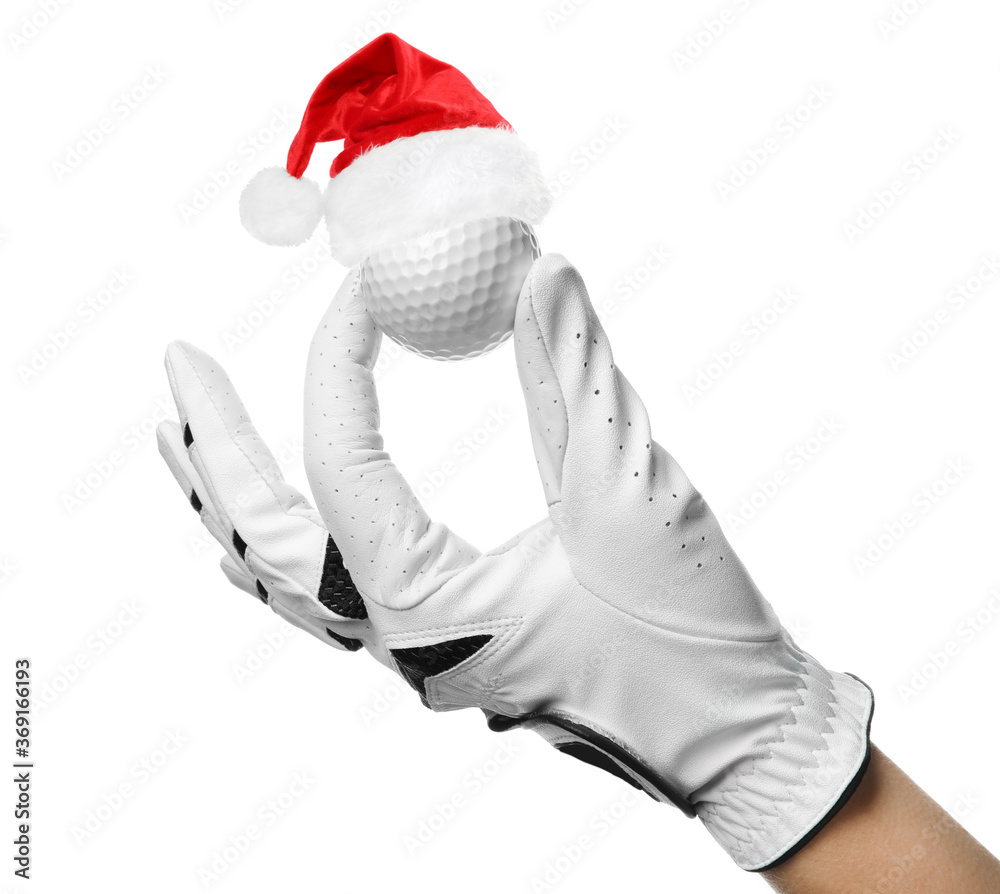 Wall mural Player holding golf ball with small Santa hat on white background, closeup