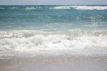 Summer background. Waves in the blue sea on a sunny day. Azure ocean with big waves.