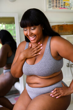 Beautiful woman laughing in underwear