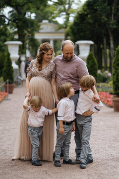 Parents with sons standing in park alley before party
