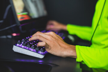 Cyber sport e-sports tournament, team of professional gamers, close-up on gamer's hands on a keyboard, pushing button, gamers playing in competitive moba/strategy fps game on a cyber games arena club
