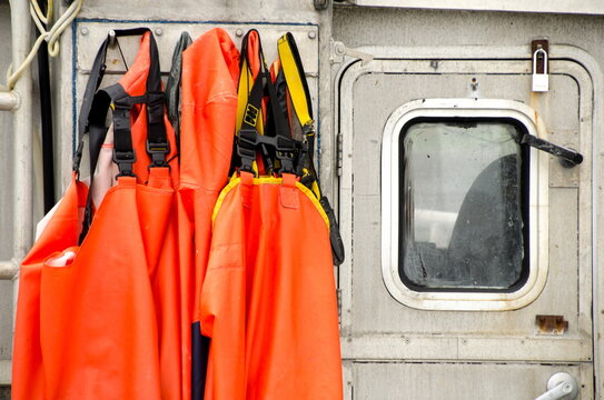 Orange Fisher Overalls Hanging On Fisher Boat