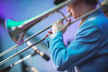 Concert view of a trombone player trombonist with musical jazz band performing