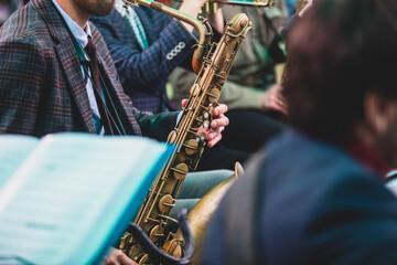 Concert view of a saxophonist, saxophone player with vocalist and musical during jazz orchestra...