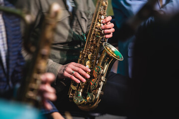 Concert view of a saxophonist, saxophone player with vocalist and musical during jazz orchestra...