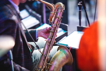 Concert view of a saxophonist, saxophone player with vocalist and musical during jazz orchestra...