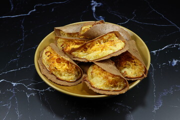 Traditional Thai crispy pancake with sweet egg floss on the plate. Famous ancient dessert or snack in the Thailand market. 