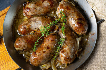 Homemade white sausage fried with onion and herbs