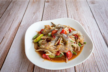 Papaya salad with shrimp in white on black background. Thai food delicious and popular