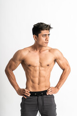 Fototapeta premium Sexy man show muscular bodies with two hands on waist stand facing forward and look side on isolated background