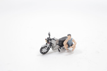 Obraz na płótnie Canvas a fun of toy figure of smoking. with motorbike