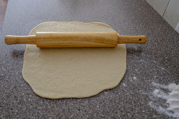Rolling pin with dough to prepare Nigerian Chin Chin