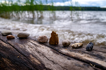 Row of stones on a log of driftwood