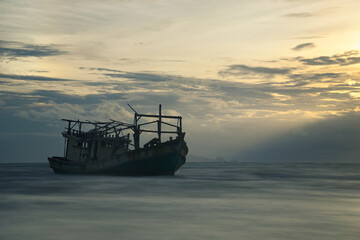 The scenery of the long-exposure of the shipwreck in sunset time at Samui island, Surat Thani province, Thailand.