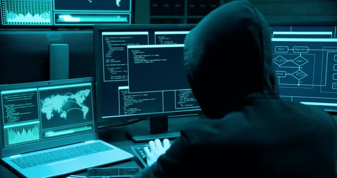Asian male hacker use laptop