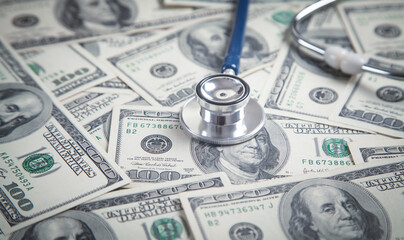 Stethoscope on dollar banknotes background.