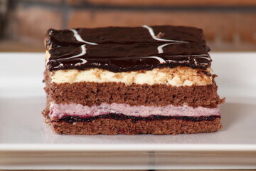 Layer cake with fruit and cream fillings decorated chocolate icing