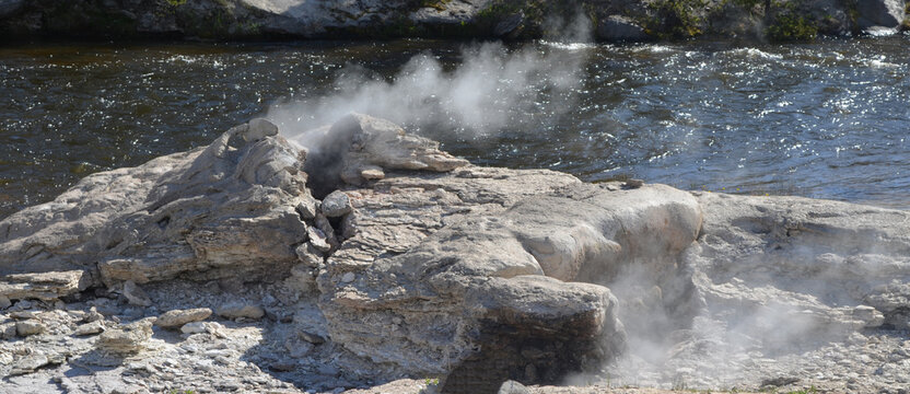 Late Spring in Yellowstone National Park: Mortar Geyser of the Morning Glory Group on the Bank of Firehole River in Upper Geyser Basin